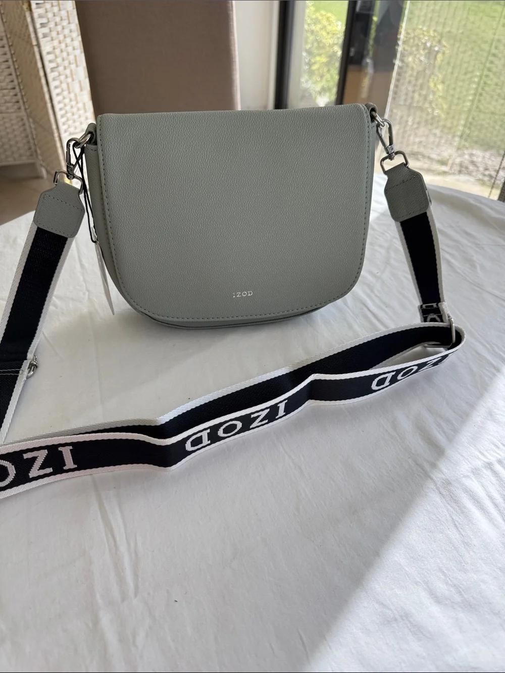 Izod Sage Pebbled Saddle Crossbody with Branded Strap